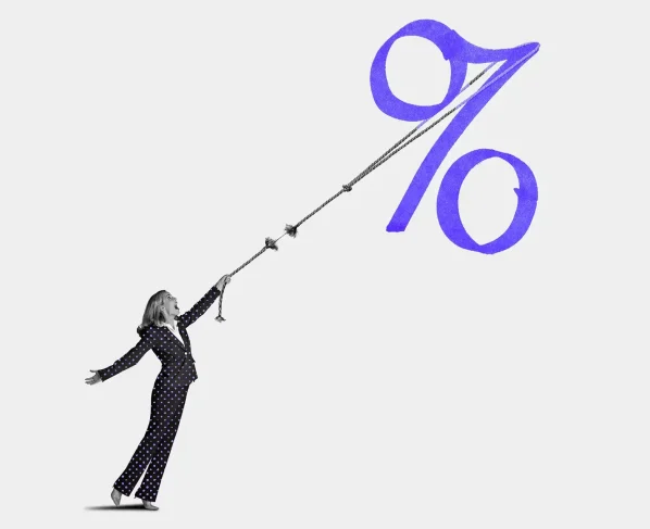Mulher em terno puxa com esforço uma corda que se rompe, presa a um grande símbolo de porcentagem.